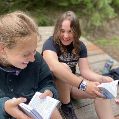Adventure Bible School Girls laughing and reading the bible